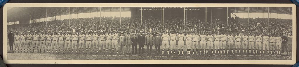 Kansas City Monarchs and Hilldale players and officials stand across the field before a large crowd at the 1924 Colored World Series.